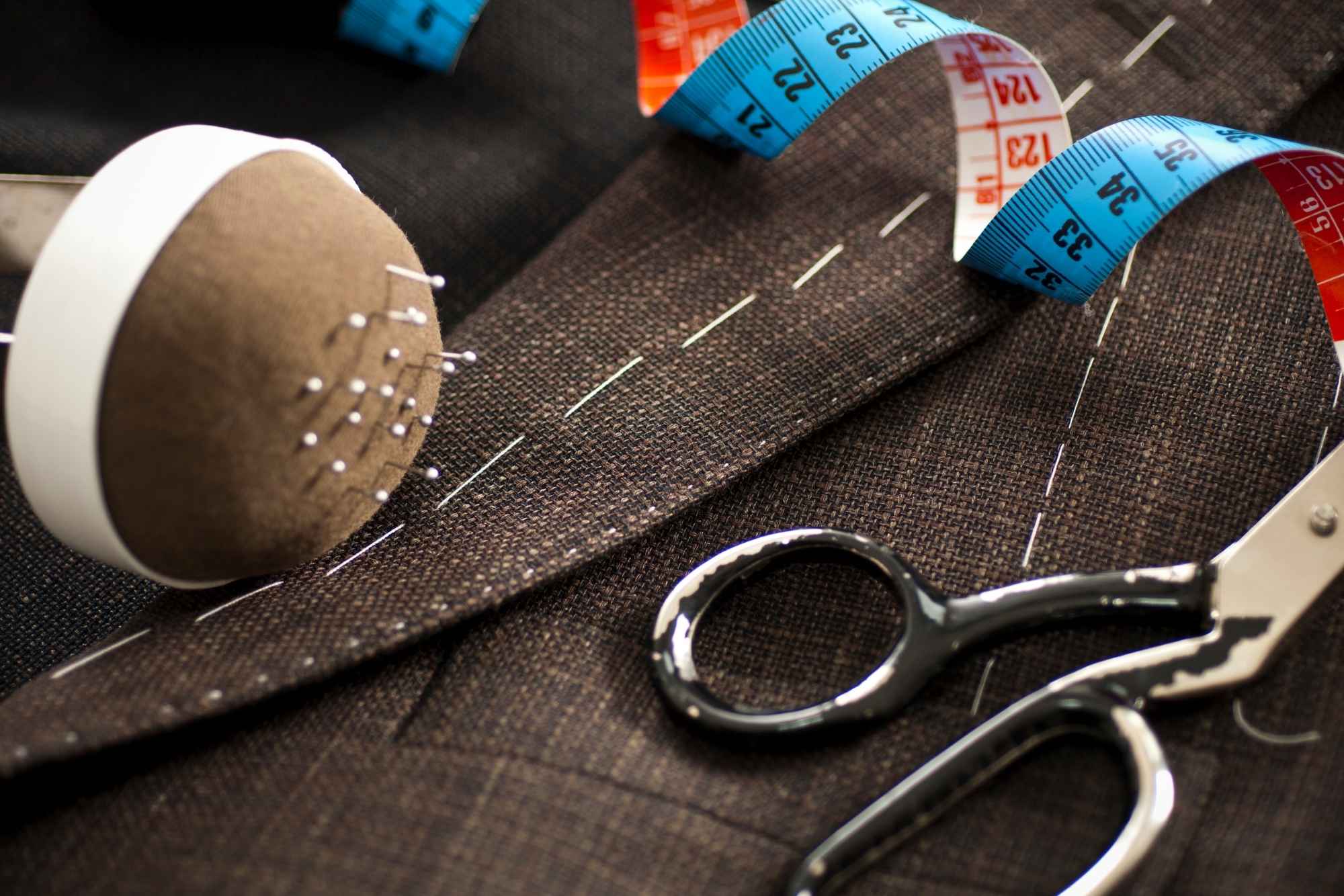Close-up of a tailored suit with white basting stitches